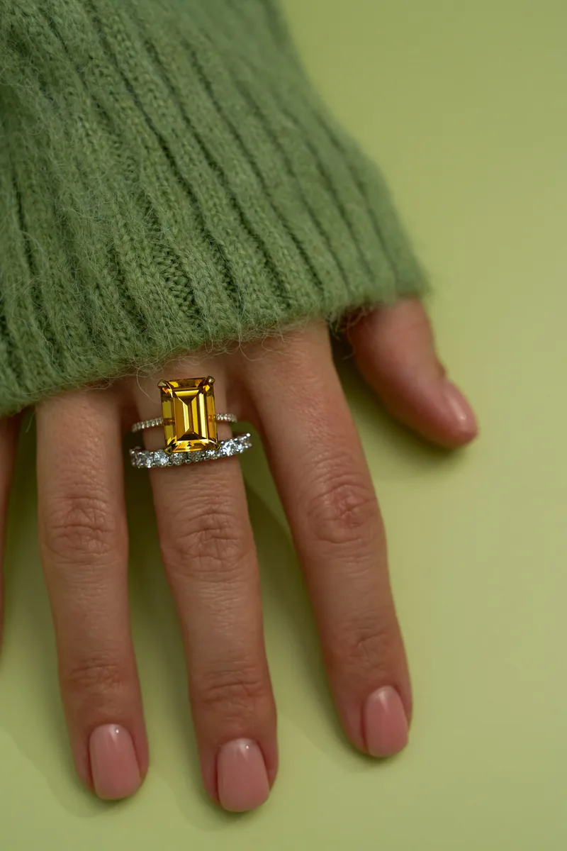 Eternity band next to a yellow diamond ring